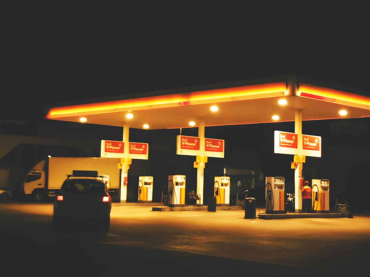 Gas station forecourt with pumps under a canopy