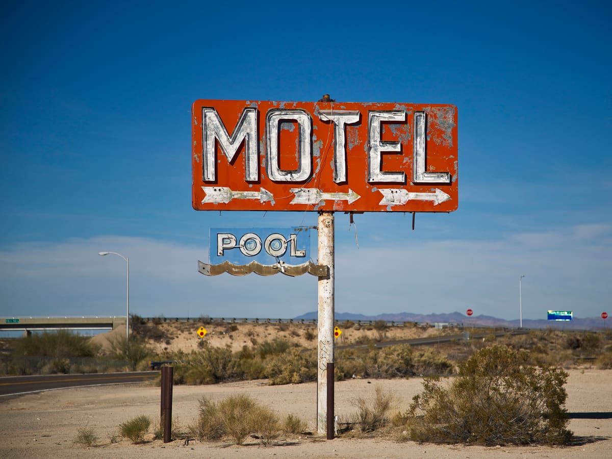 Roadside motel with a lit sign